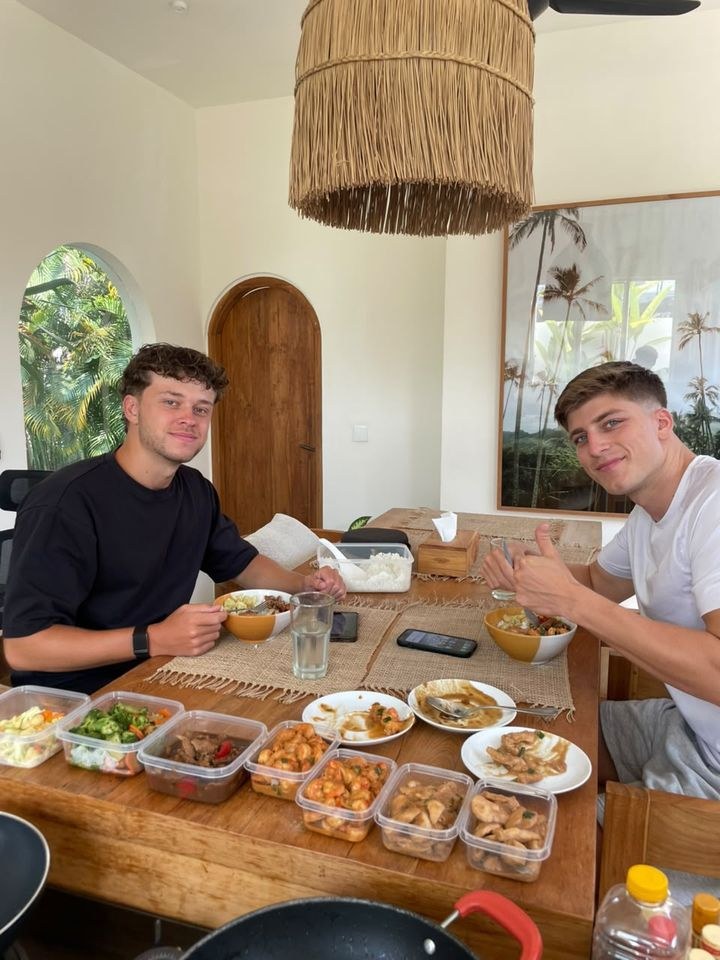 Two happy guests at their villa table with home-cooked meals from private chef Muna in Canggu